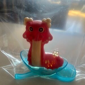 Red and Cream Dragon Figurine with Blue Base